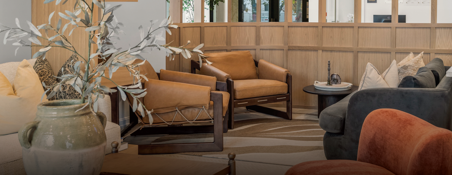 a lounge  with chairs a couch, and table