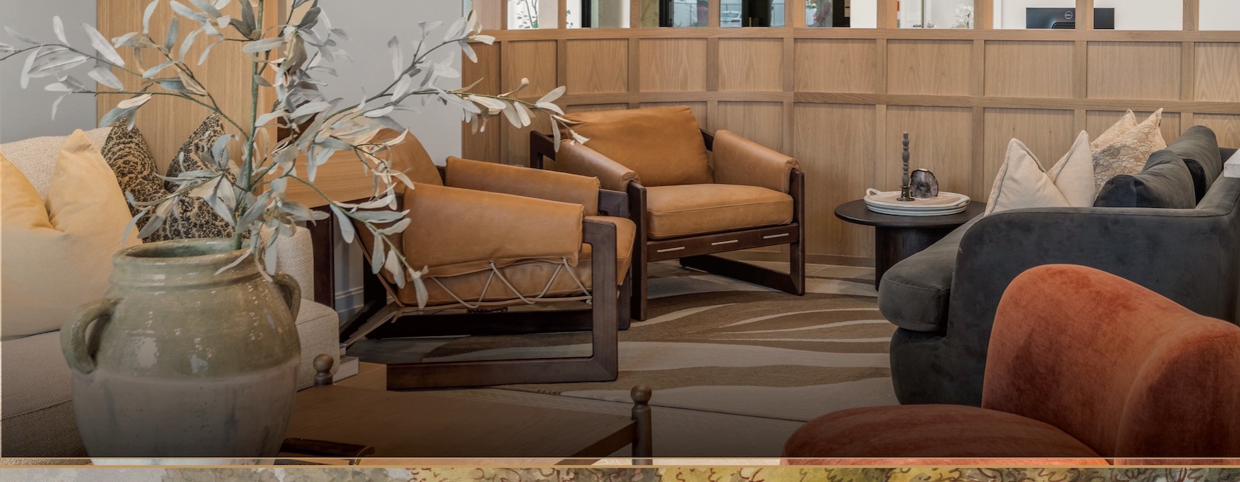 a lounge  with chairs a couch, and table