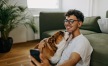 a man holding his pet in a living room